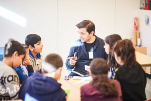 Portrait of a guest-teacher with TADA kids.